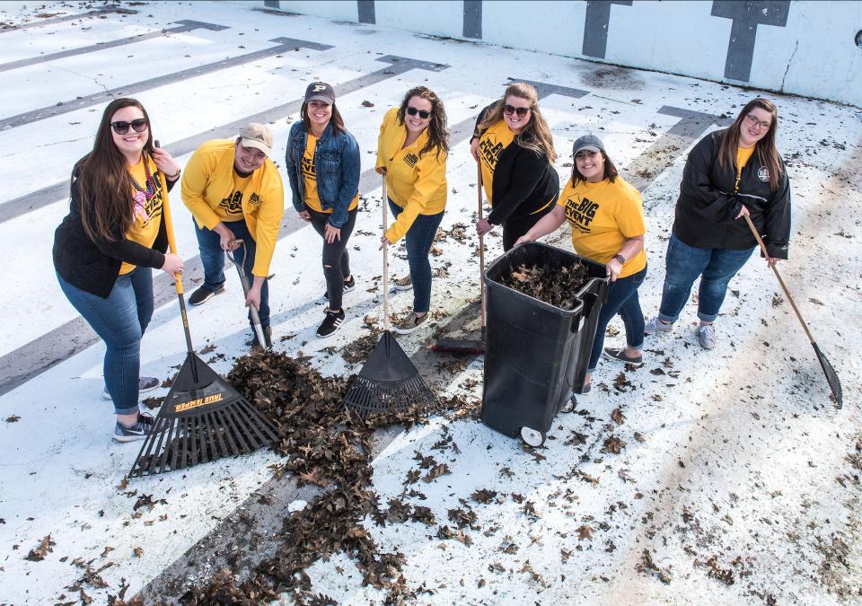 Students raking leaves