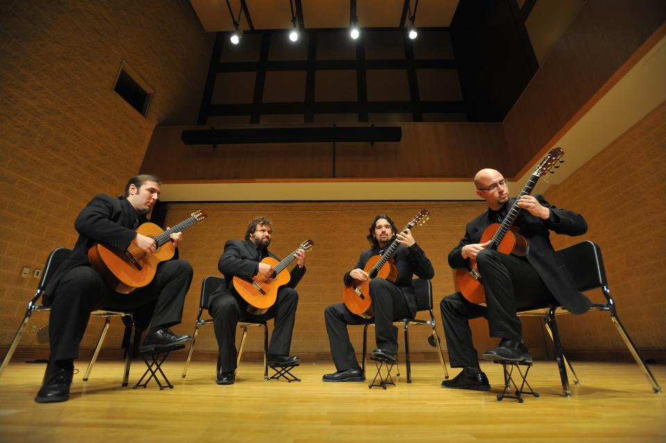 group playing guitar on stage