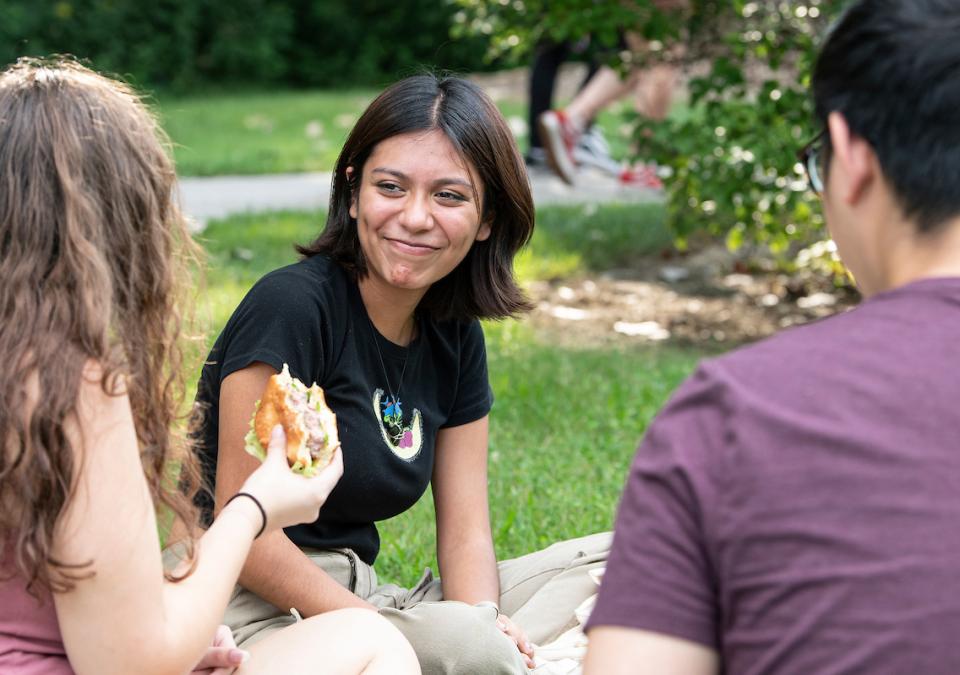 Students eating together outside.
