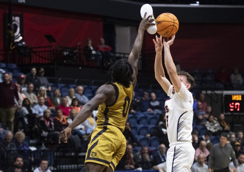 Rasheed Bello blocks a shot with his shoe (photo courtesy of MaCabe Brown of the Evansville Courier & Press)