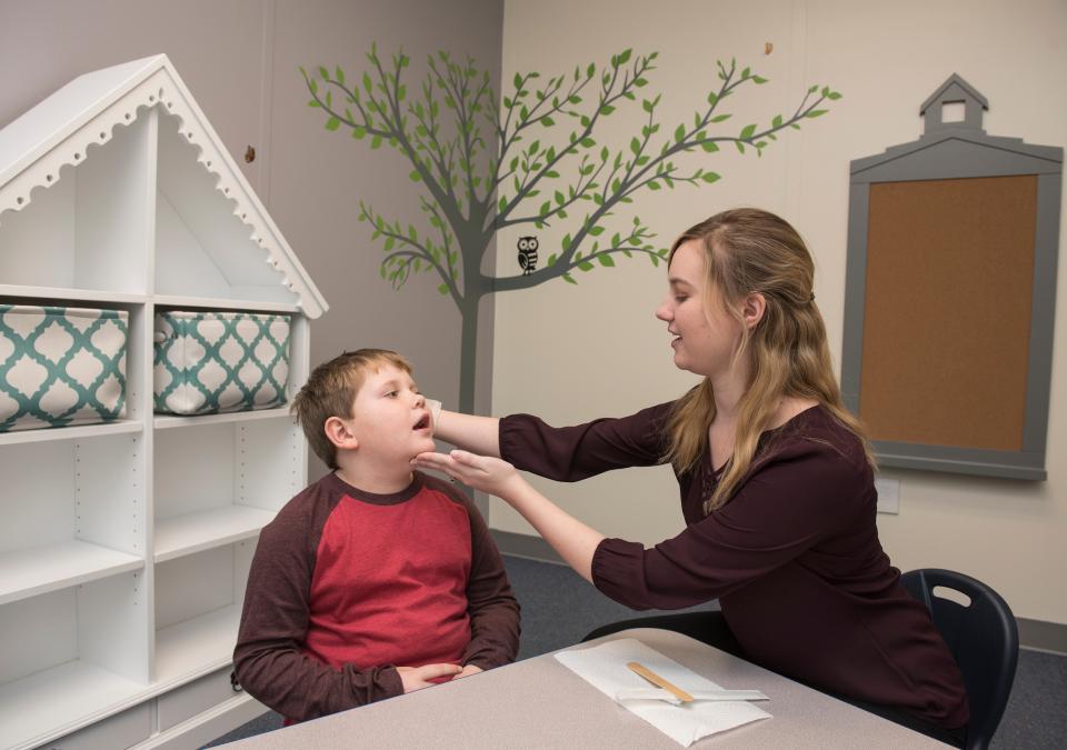 Speech language pathologist working with patient