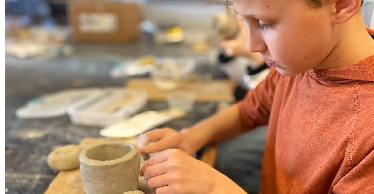 child making pottery