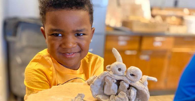 child making pottery