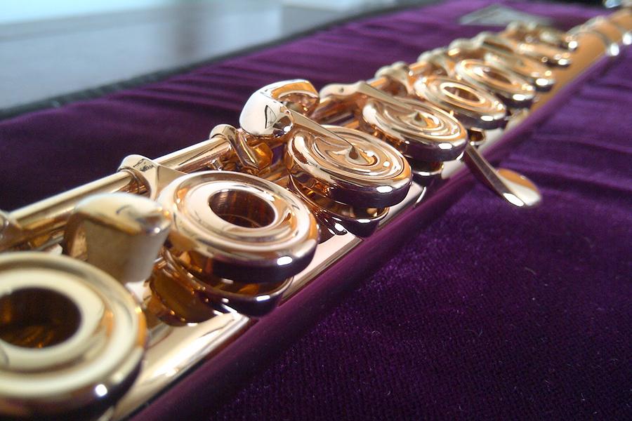 upclose picture of flute on purple cloth