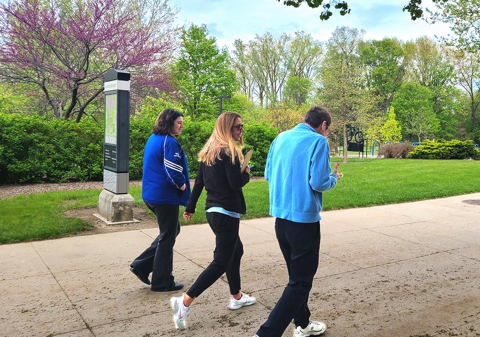 Health Coach walking on campus with members of faculty and staff.