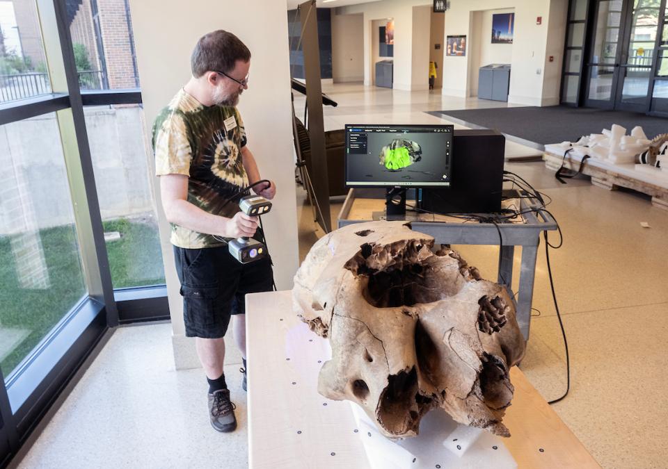 Graham Fredrick, library systems specialist, was part of a team including Erika Mann, director of library technology and digital initiatives, and Daniel Lin, information services technician, who scanned the baby mastodon’s skull for 3D digitization.