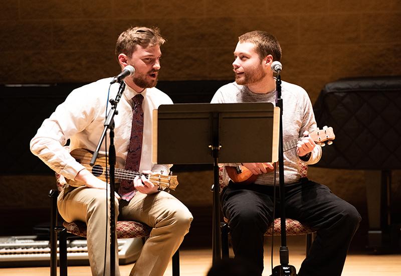 two men playing guitars