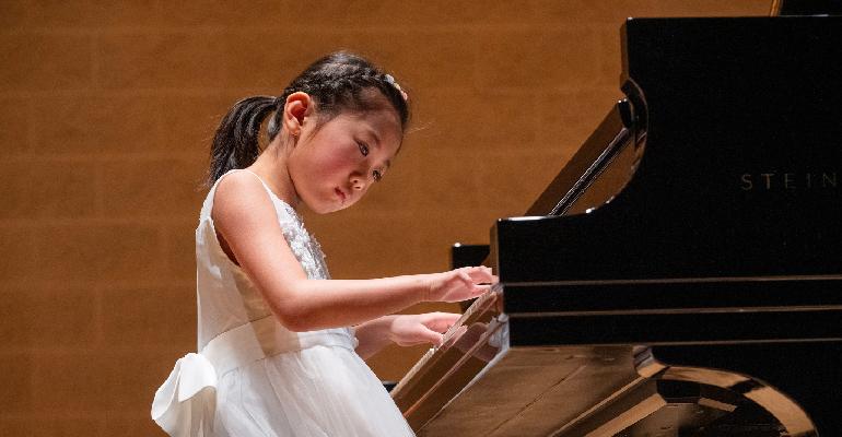 young girl playing piano