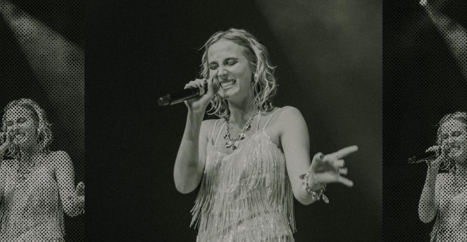 vocalist smiling and performing