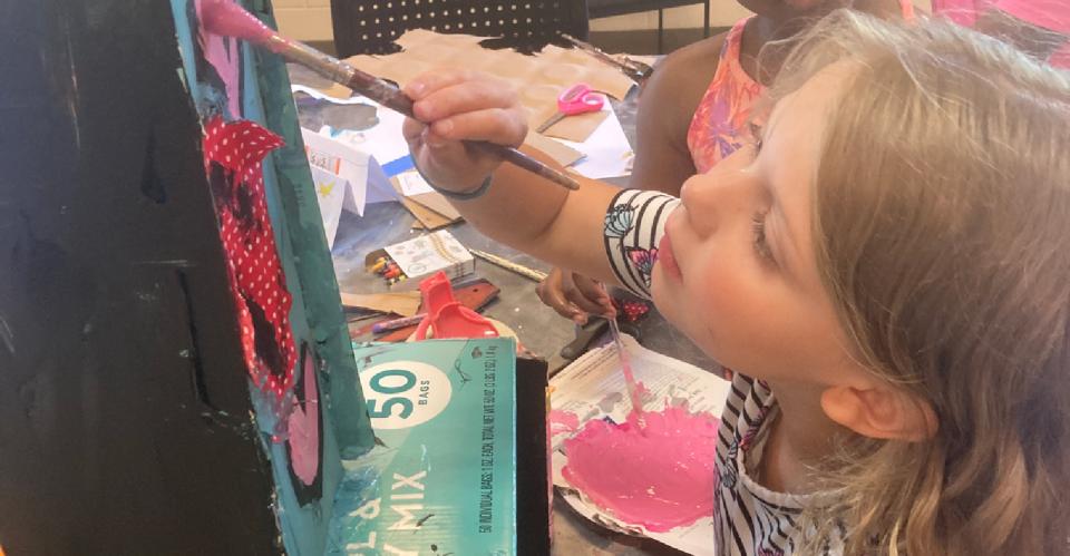 child painting on canvas creatively