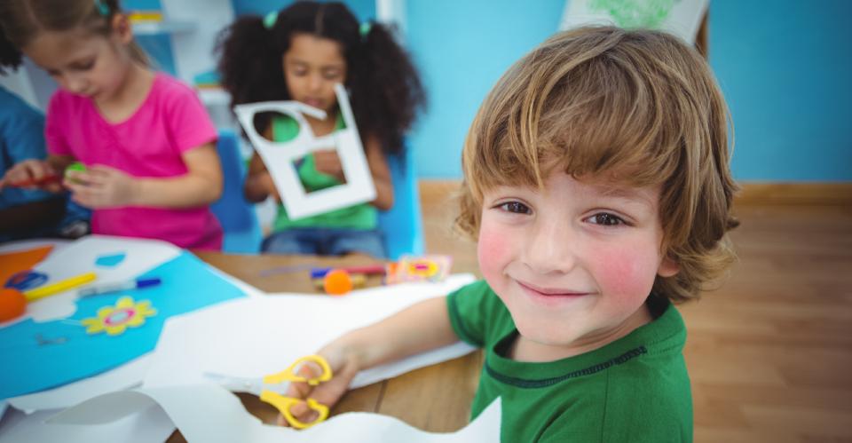 child making paper creation with scissors
