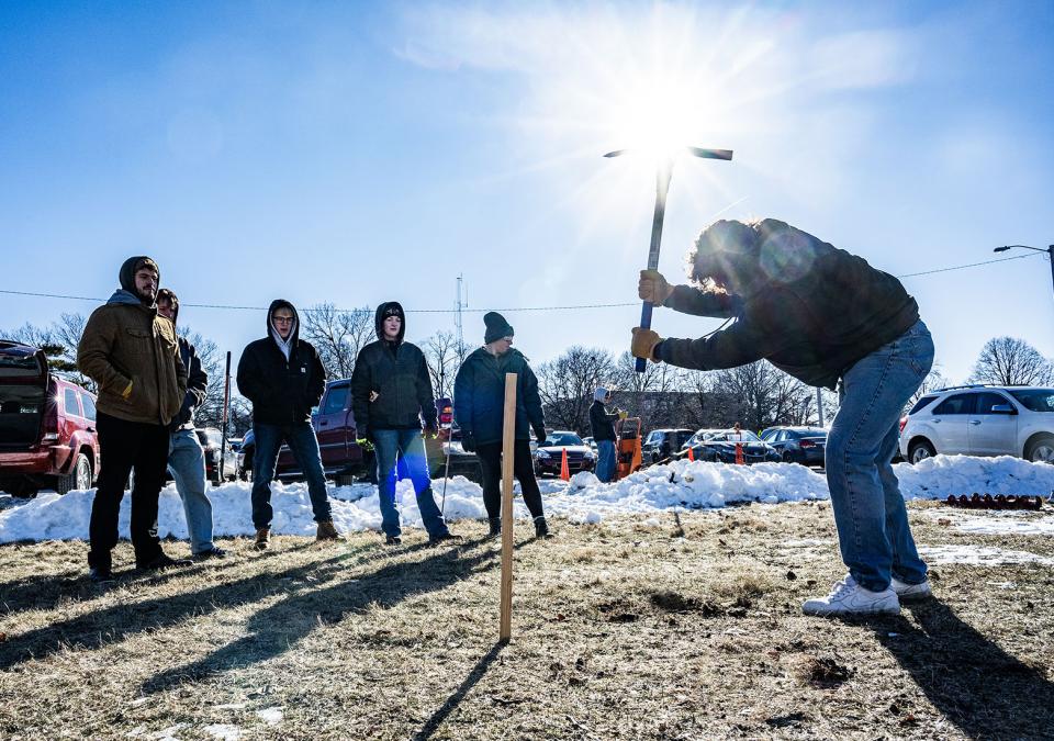 Civil Engineering students are using a pickaxe to take a soil sample