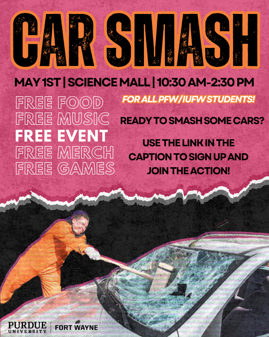 A male in an orange jumpsuit using a sledgehammer to smash the window on a grey car