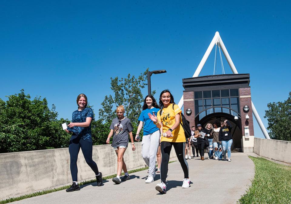 Students are walking near the pedestrian bridge