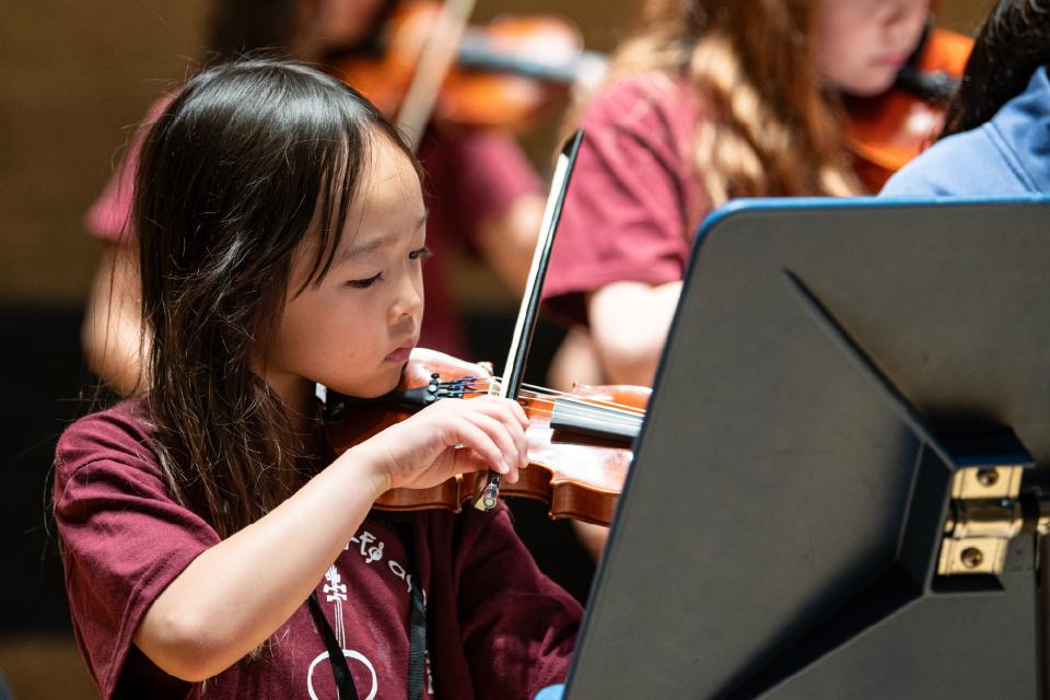 young child playing violin