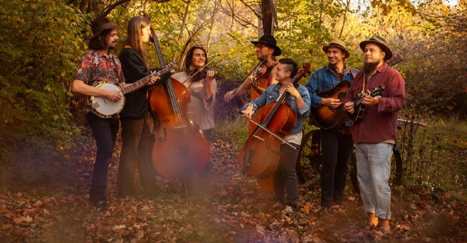 group of bluegrass musicians in a field