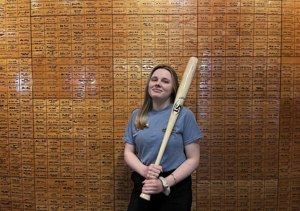 Hailey Bower holding a baseball bat
