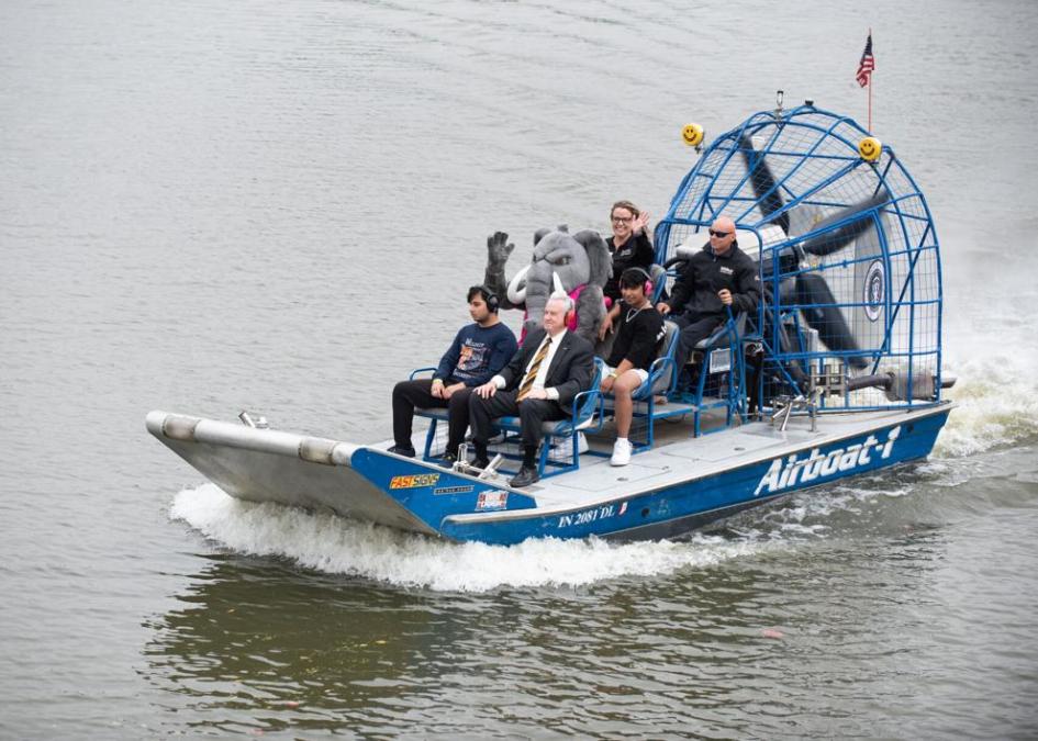 Airboat on the river with multiple people on it including the Mastodon