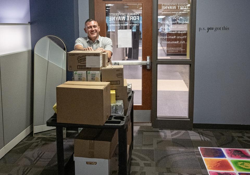 Eric Manor is moving items into the new pantry location in Kettler Hall