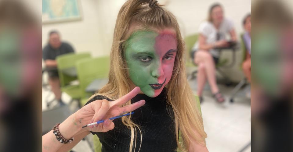 child doing face make up