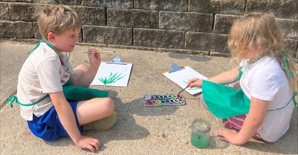 children painting outside