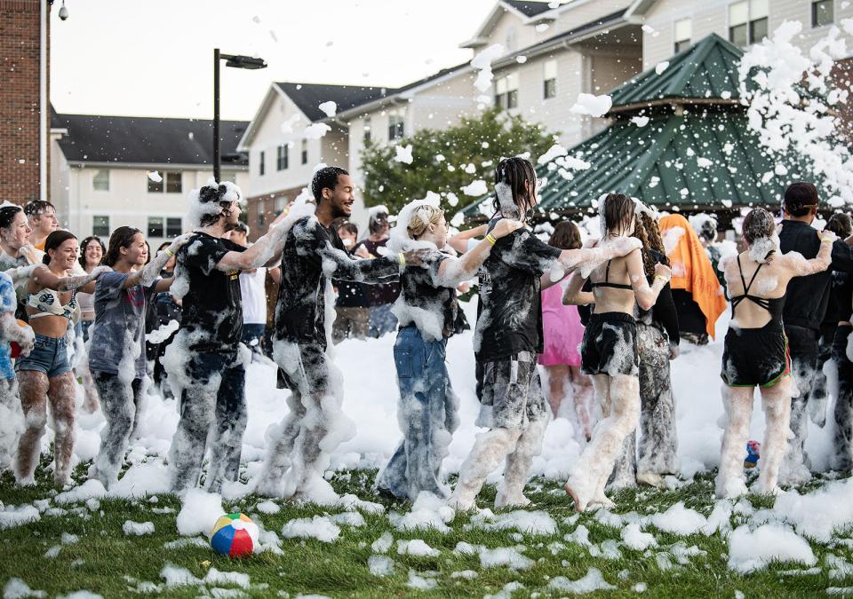 Students line dancing at the Foam Party at the Disco