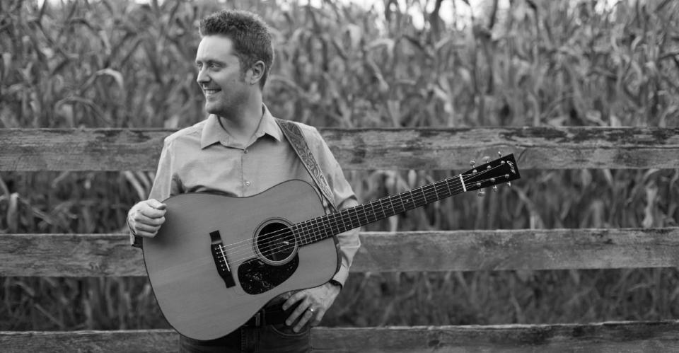 man holding guitar