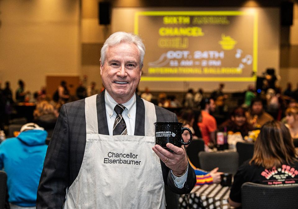 Chancellor Ron Elsenbaumer is holding a bowl of chili