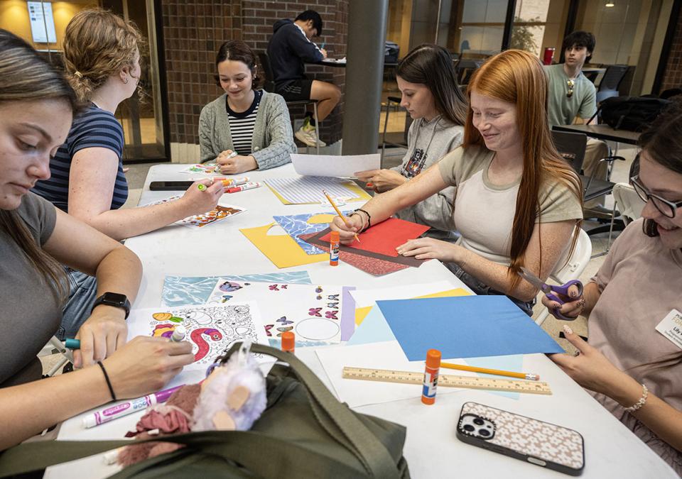 Students are crafting while sitting at a table