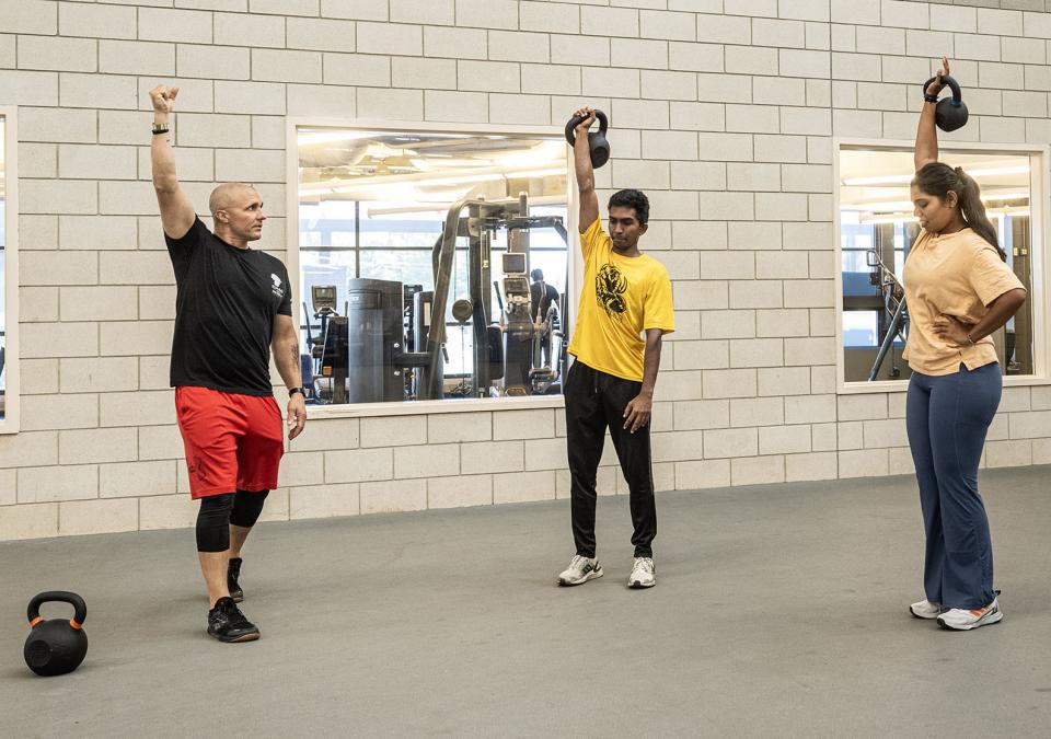 A police officer is leading a CrossFit class