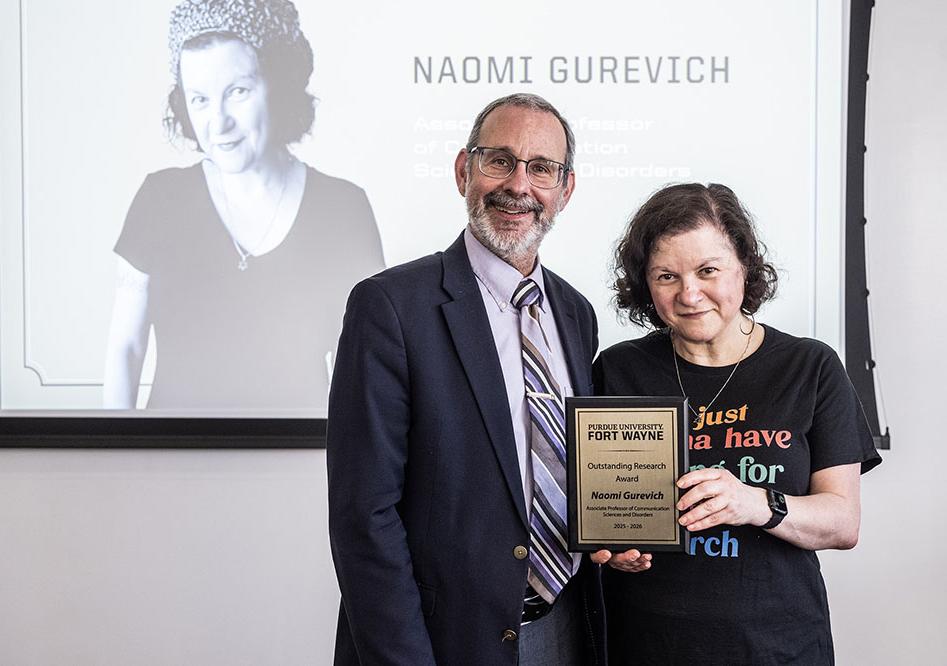 Dean Ron Friedman is presenting an award to Naomi Gurevich