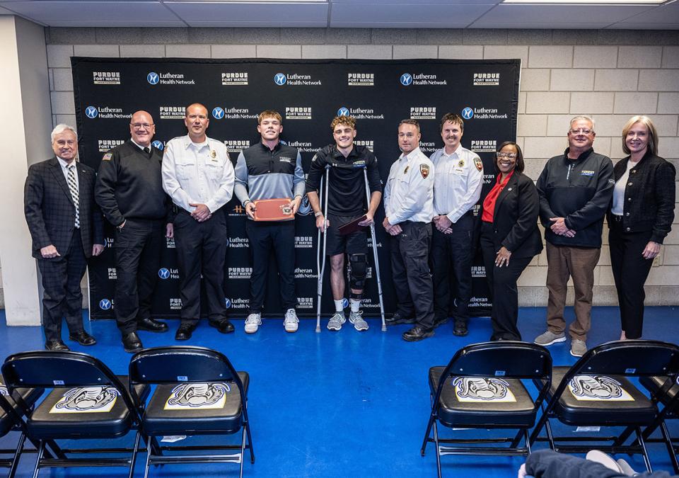 Several people are gathered for an award ceremony