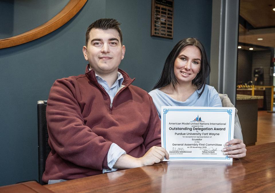 Nate Wilcox and Matilda Radcliffe display their award