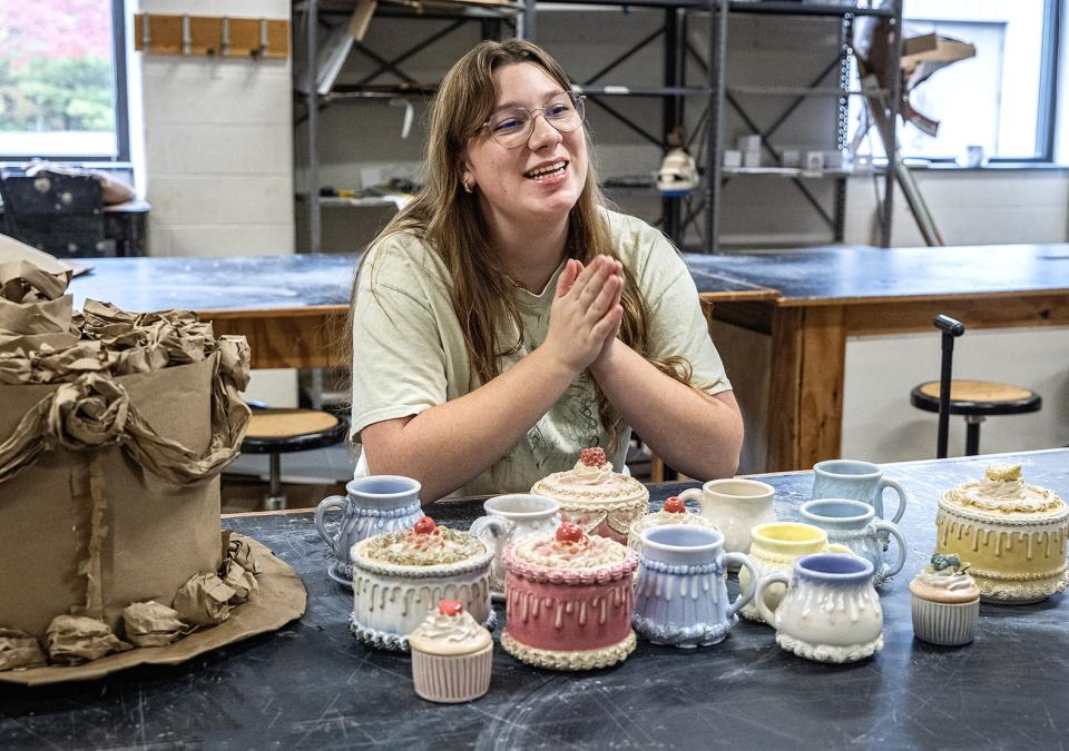 Teagan Koble with several of her ceramic pieces