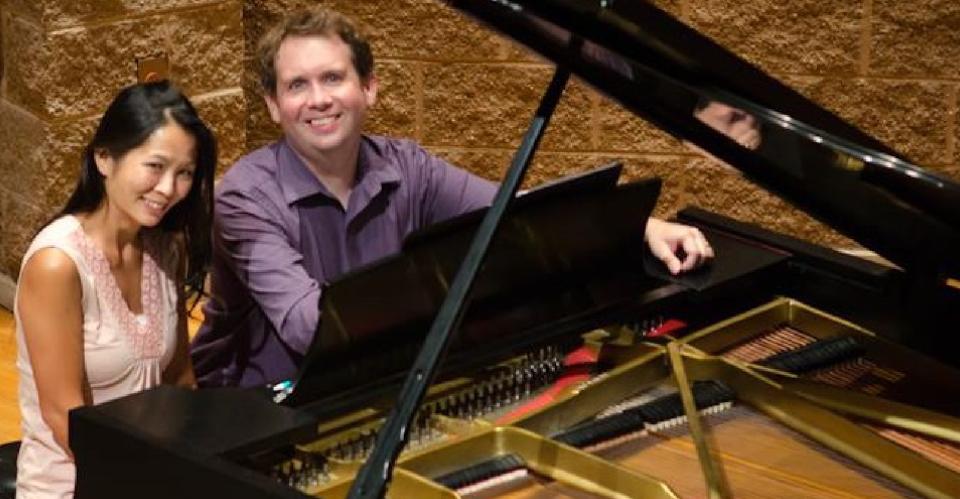 couple sitting at piano