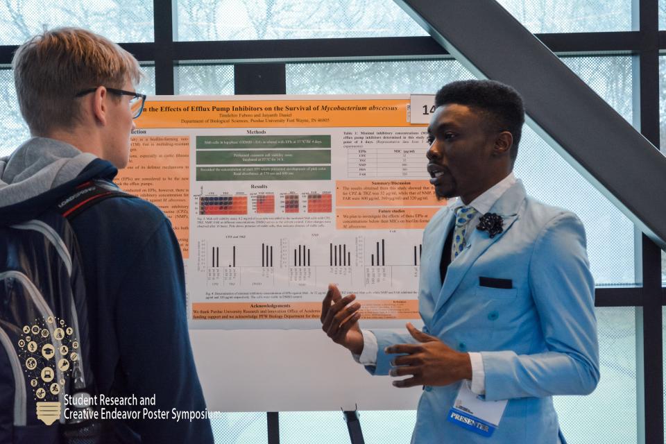 Student with research poster