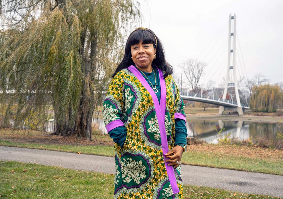 Stacy Abraham is on campus standing near a bridge