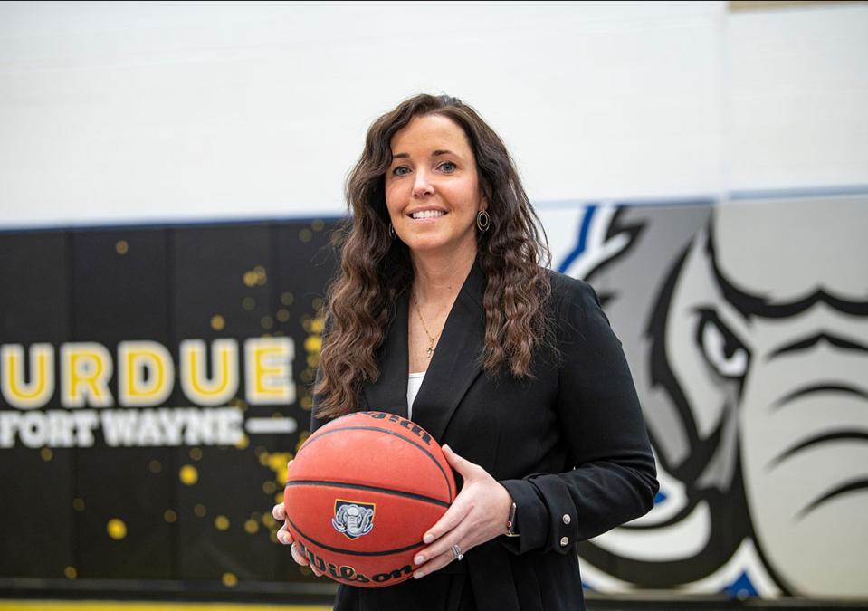 Coach Maria Marchesano is holding a basketball
