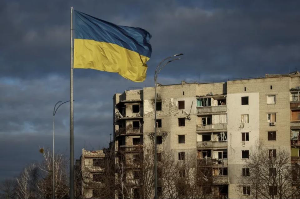 Ukraine flag flying in front of a building