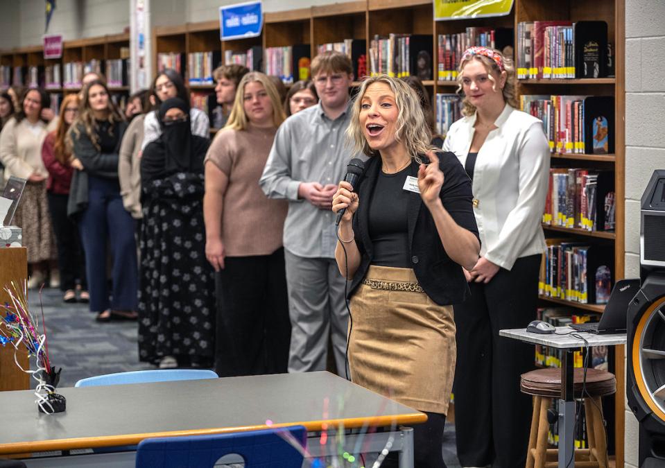 School of education students are lined up in front of a classroom