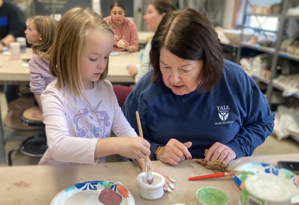 woman and child painting pottery