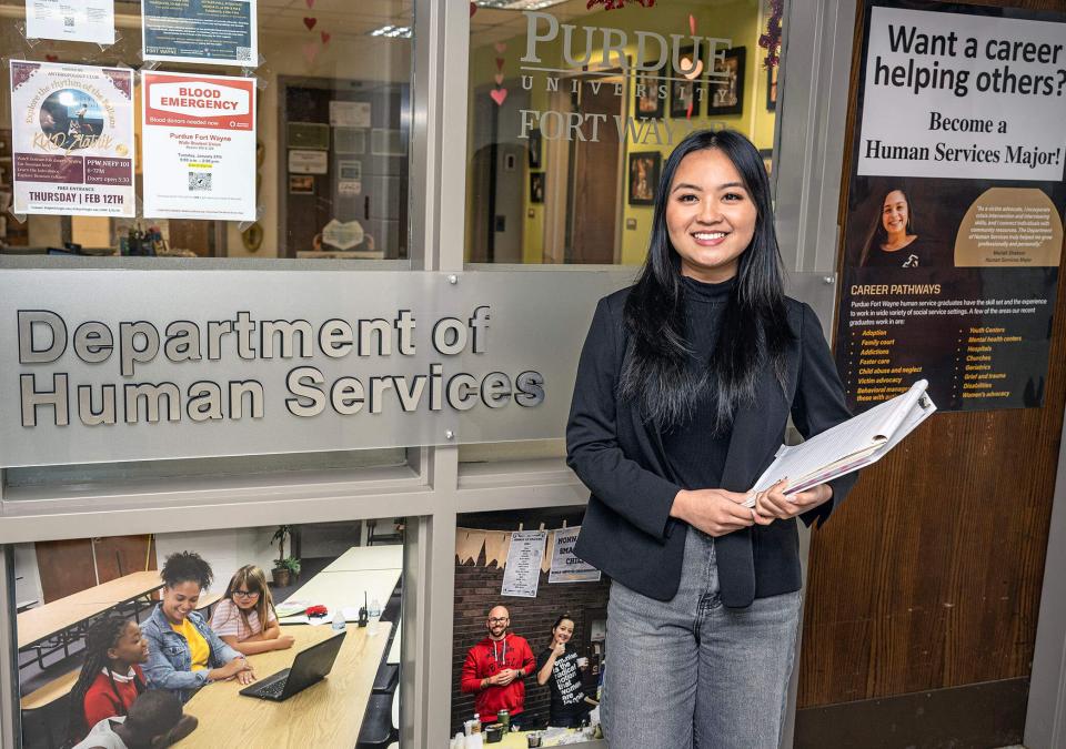 Mansan Kiim is standing outside of a department