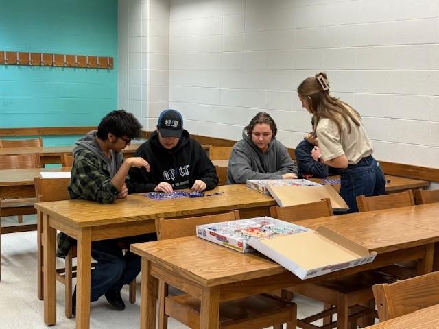 High school students doing a circuit connection activity with a student ambassador