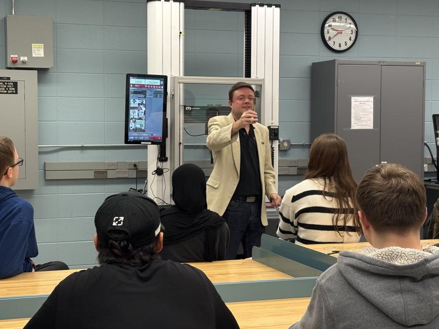 Professor showing item to high school student tour