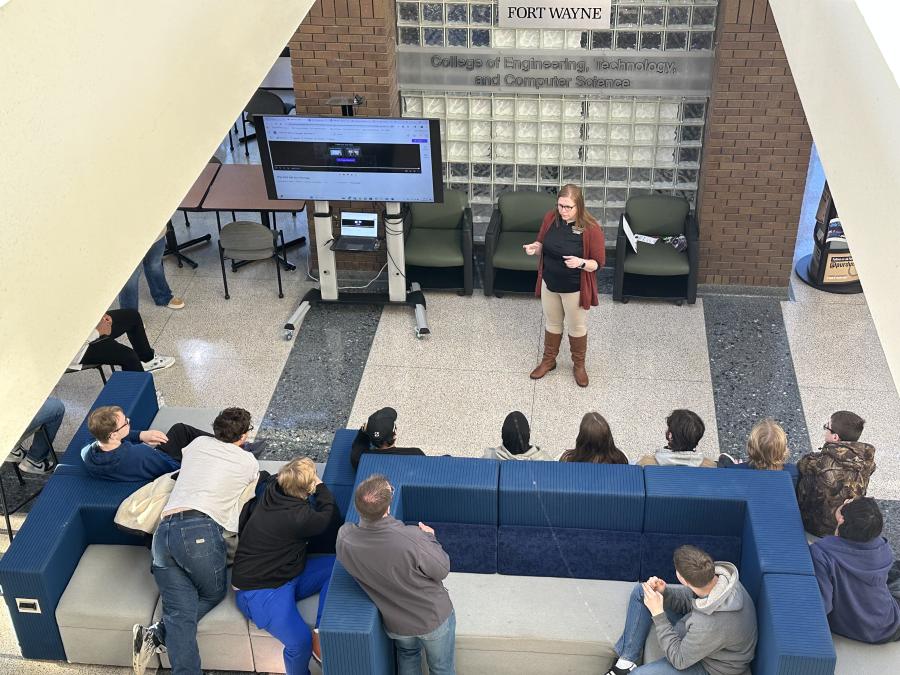 Director of ETCS giving opening statement to high school students before tours start in lobby
