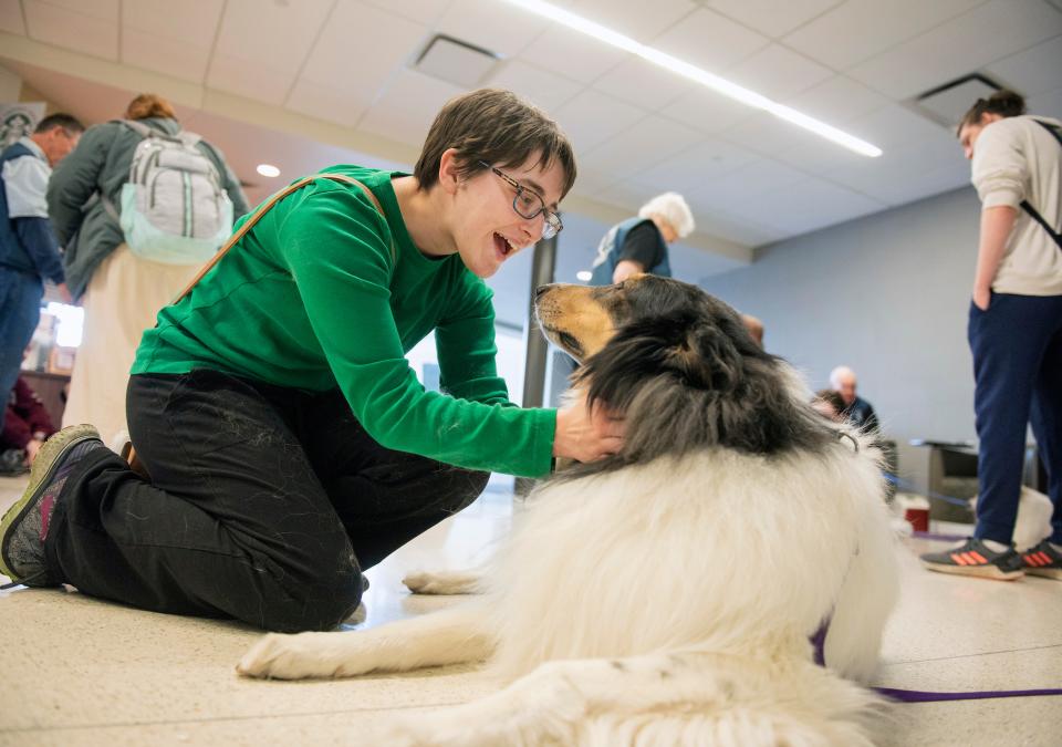 A student petting a therapy dog.