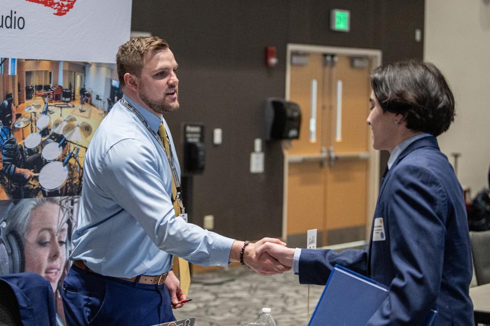 Prospective employer shaking student's hand