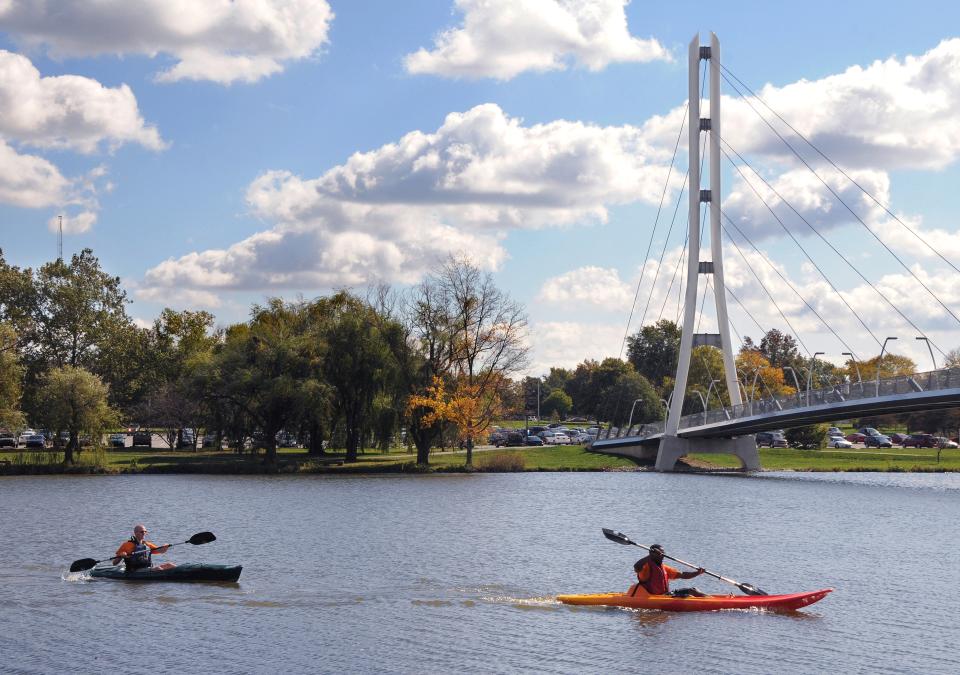 Kayaks on the St. Joseph River with the Ron Venderly Family Pedestrian bridge in the background.