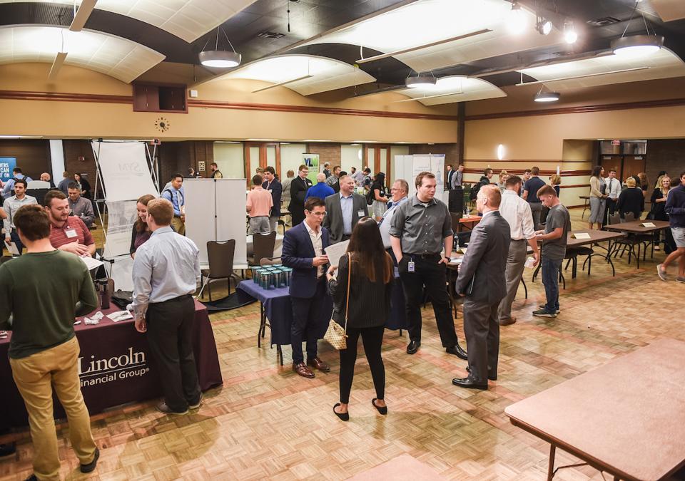 Students collecting information on careers at an accounting event on campus.