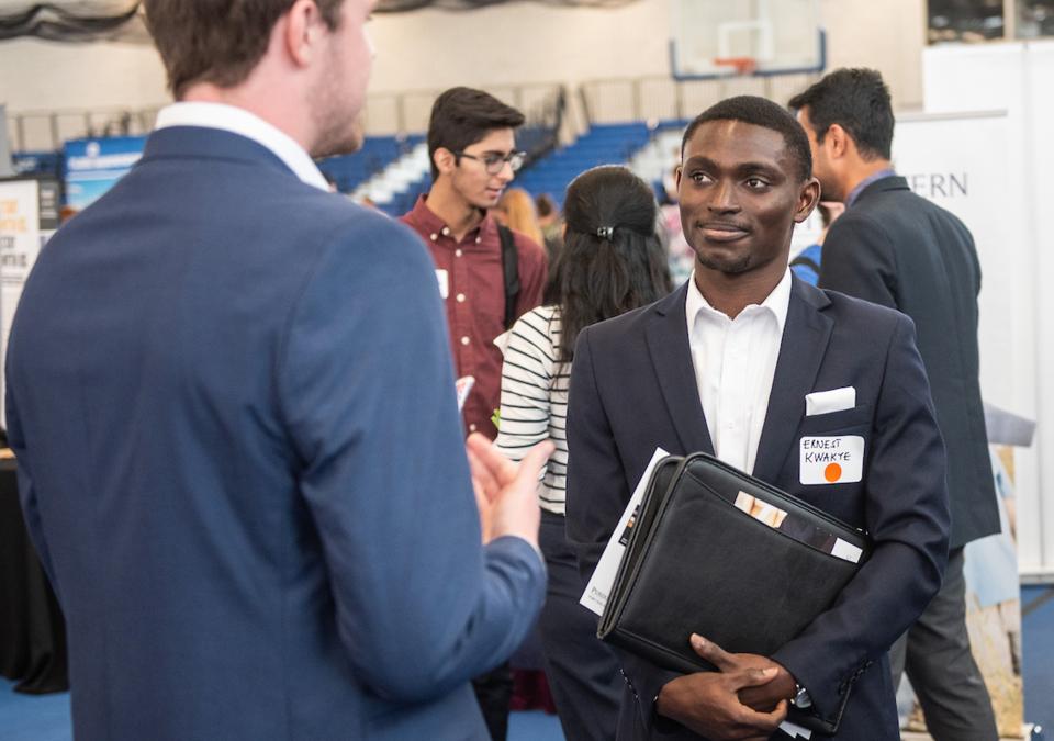 Student collecting information on careers at the career fair.